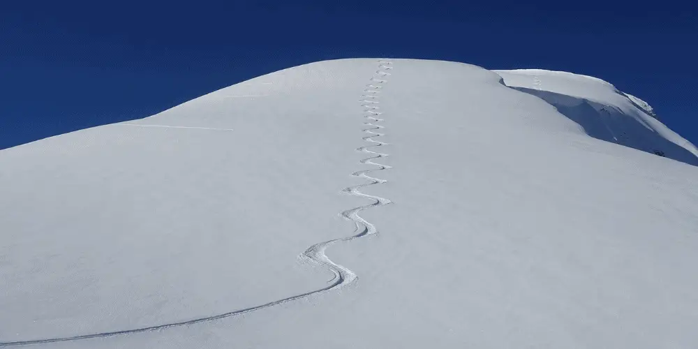 Skill fall line in slushy snow.