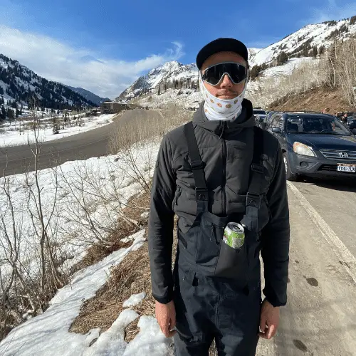 Man wearing ski bibs in Little Cottonwood Canyon