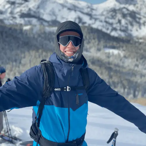 Man with face tube backcountry skiing