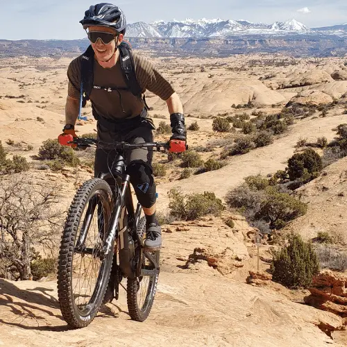 Mountain biker climbing slick rock in Moab Utah